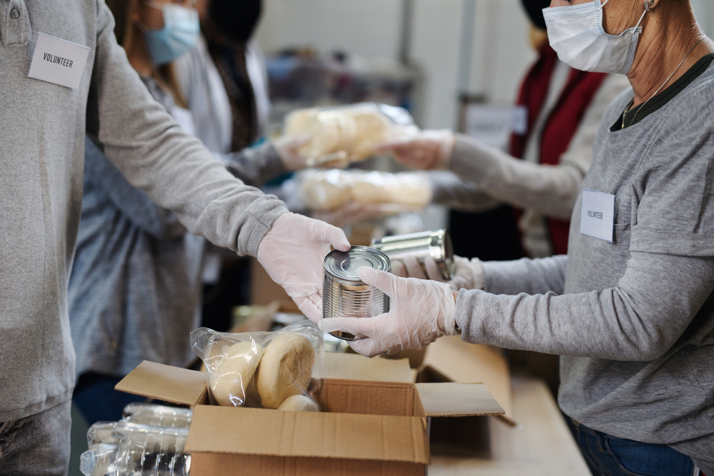 Volontari preparano le donazioni di cibo - Povertà alimentare